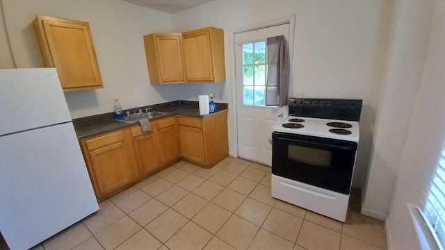 kitchen featuring light tile patterned flooring, white appliances, and sink