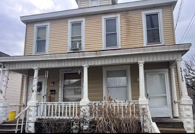 view of front of property featuring cooling unit and covered porch