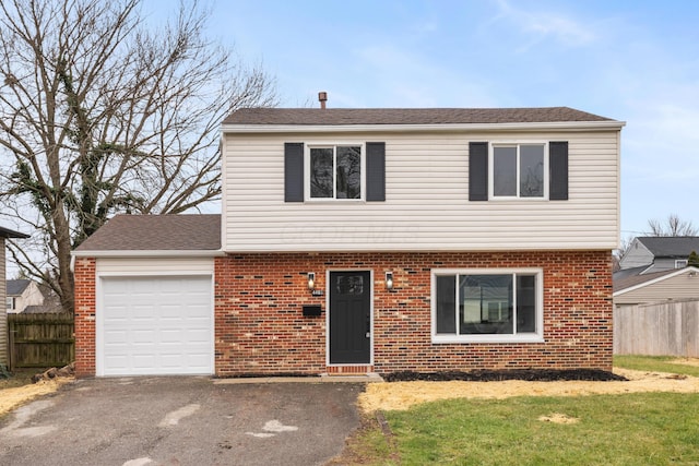 front of property with a front yard and a garage