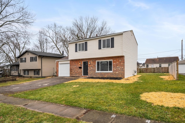 view of front of house with a garage and a front lawn