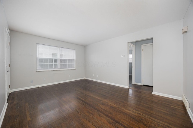 empty room with dark hardwood / wood-style floors