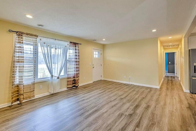 unfurnished room with light wood-type flooring