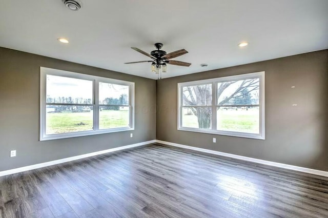 empty room with dark hardwood / wood-style floors and ceiling fan