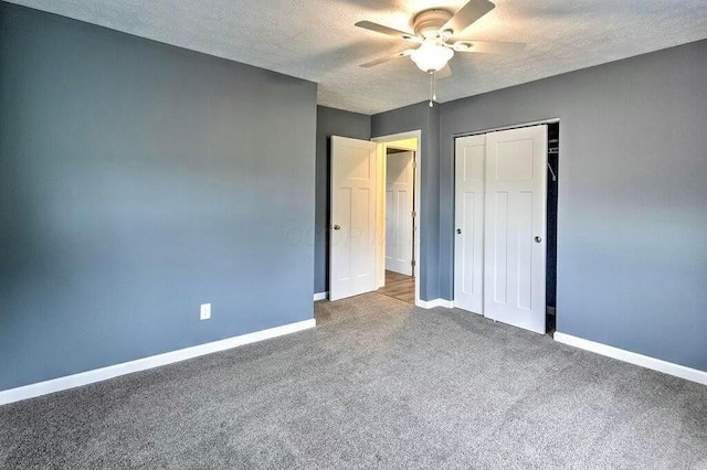 unfurnished bedroom featuring carpet, ceiling fan, a textured ceiling, and a closet