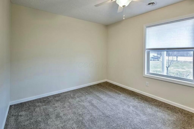 spare room with carpet floors, plenty of natural light, and ceiling fan