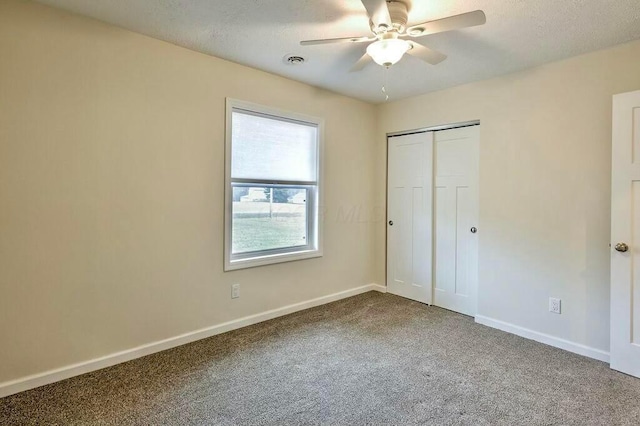 unfurnished bedroom with carpet, ceiling fan, and a closet