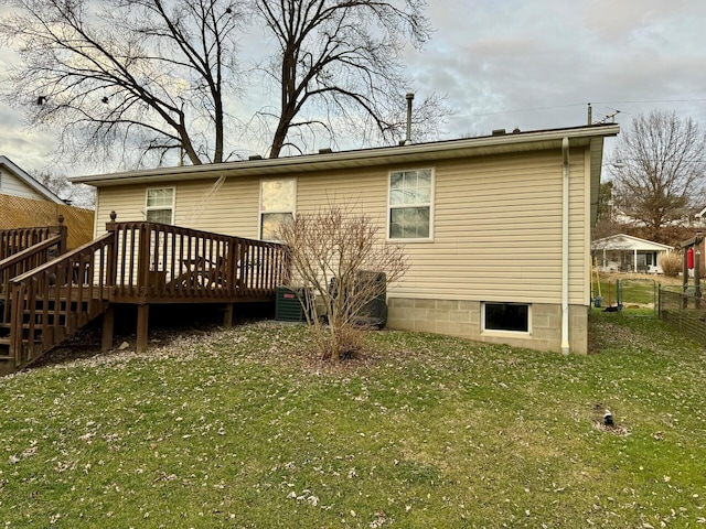 rear view of property with a deck, a lawn, and central air condition unit