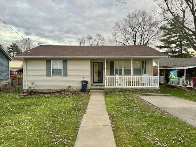 view of front facade with a front yard and a porch