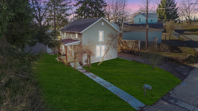 outdoor structure at dusk featuring a yard