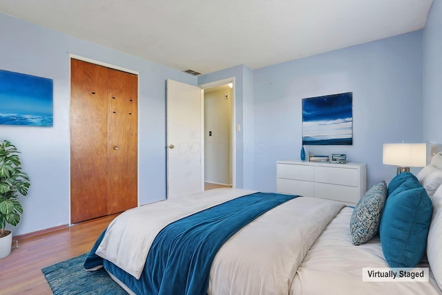 bedroom featuring light hardwood / wood-style floors and a closet