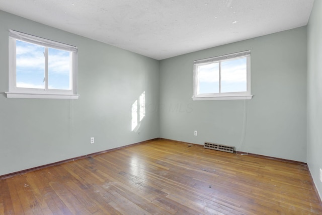 empty room with light hardwood / wood-style floors