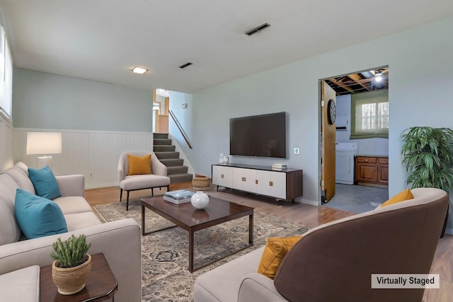 living room featuring light hardwood / wood-style flooring and washer / dryer