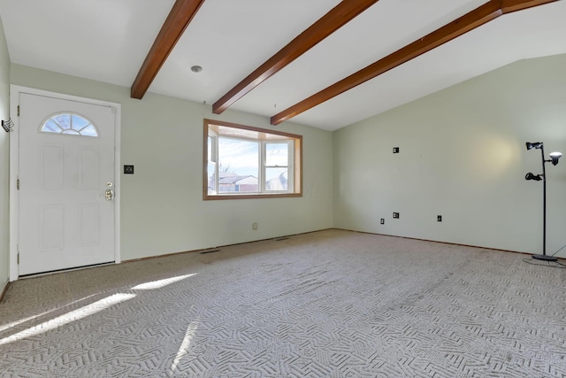 carpeted foyer entrance with vaulted ceiling with beams