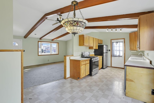 kitchen featuring plenty of natural light, sink, appliances with stainless steel finishes, and light carpet