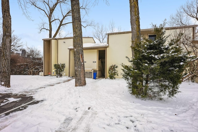 view of snow covered back of property