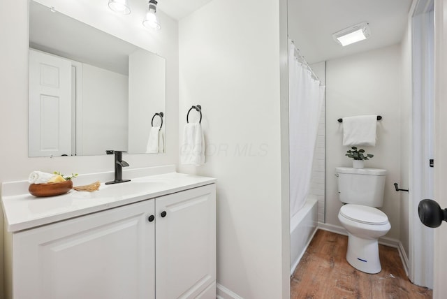 full bathroom with hardwood / wood-style flooring, vanity, toilet, and shower / tub combo with curtain