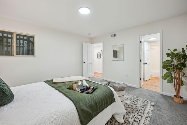 bedroom with carpet flooring and ensuite bathroom