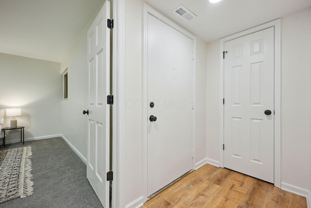 corridor with wood-type flooring