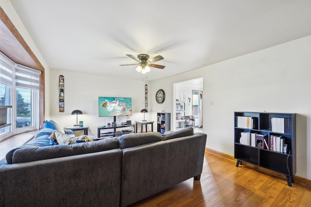 living room featuring ceiling fan and hardwood / wood-style flooring