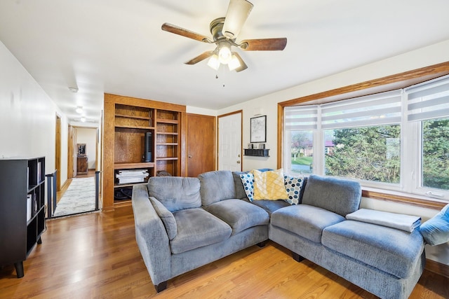 living room with hardwood / wood-style floors and ceiling fan