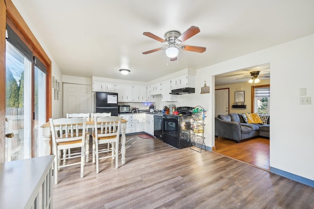 kitchen with ceiling fan, dark hardwood / wood-style flooring, white cabinets, and black appliances