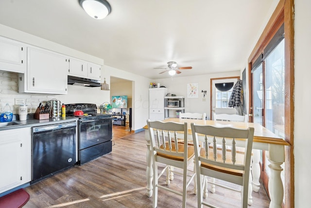 kitchen with white cabinets, hardwood / wood-style floors, ceiling fan, and black appliances