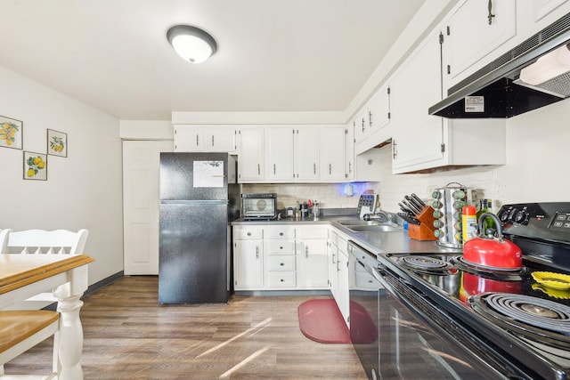 kitchen with decorative backsplash, sink, black appliances, white cabinets, and dark hardwood / wood-style floors