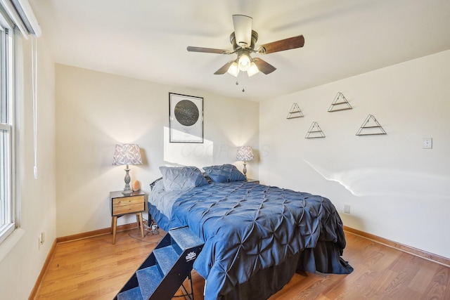 bedroom featuring hardwood / wood-style flooring and ceiling fan