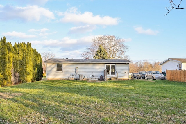 rear view of property with a yard