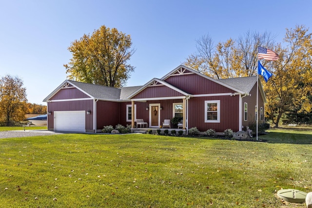 view of front facade with a front lawn, a porch, and a garage