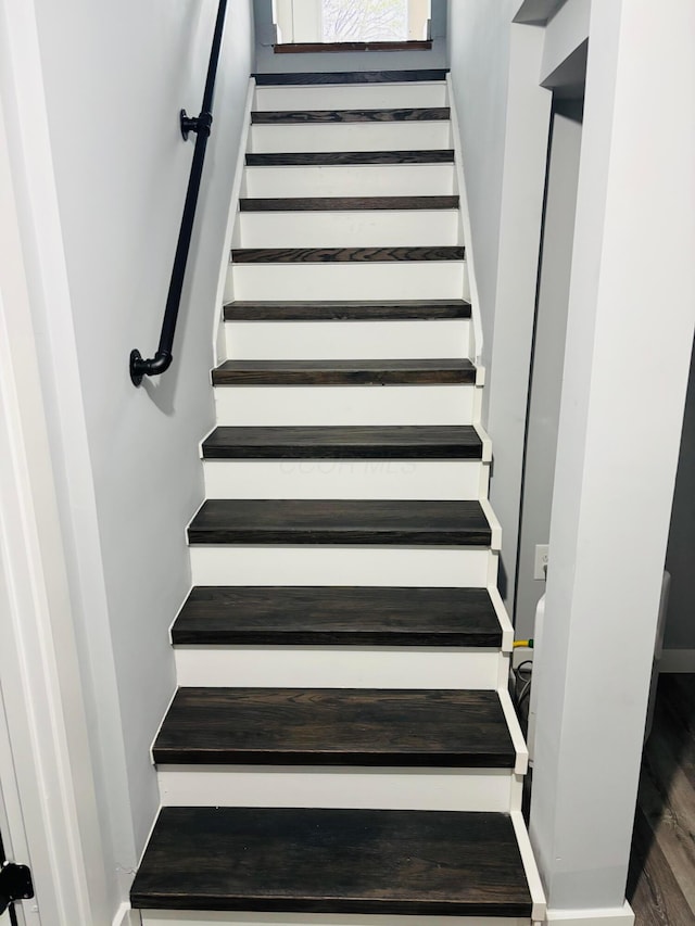 staircase with hardwood / wood-style floors