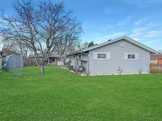 view of property exterior with a lawn