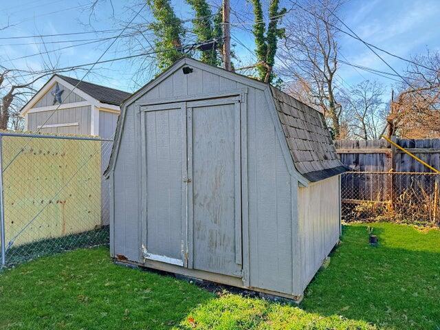 view of outbuilding with a yard