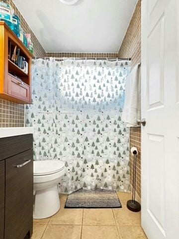 bathroom with tile patterned flooring, vanity, toilet, and a shower with shower curtain