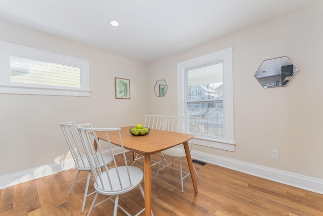 dining room with a healthy amount of sunlight and light wood-type flooring