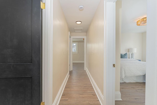 corridor with light hardwood / wood-style flooring