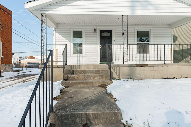 view of snow covered property entrance