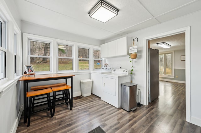 laundry room with cabinets, separate washer and dryer, and dark hardwood / wood-style floors