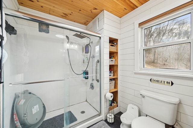 bathroom with plenty of natural light, wooden ceiling, and a shower with shower door