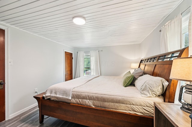 bedroom with wood ceiling and dark wood-type flooring