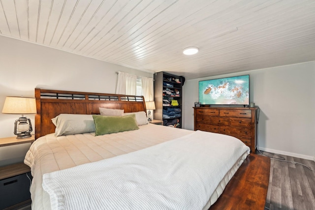 bedroom featuring dark hardwood / wood-style floors and wood ceiling