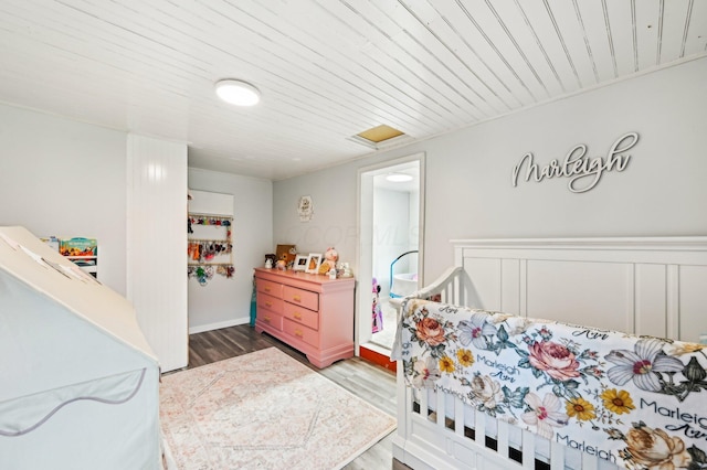 bedroom featuring hardwood / wood-style floors and wood ceiling