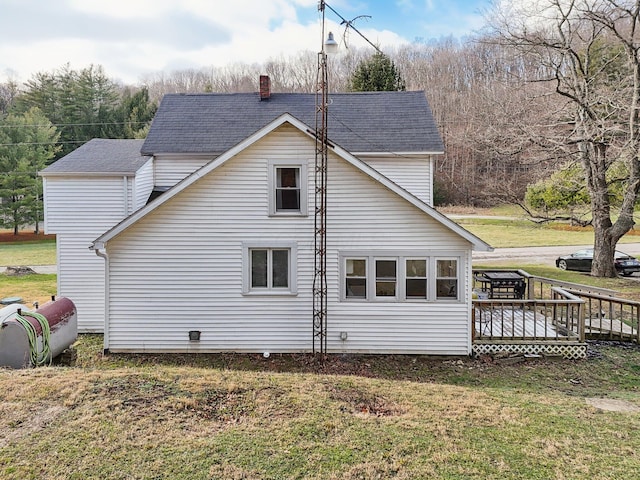 view of home's exterior featuring a yard and a wooden deck