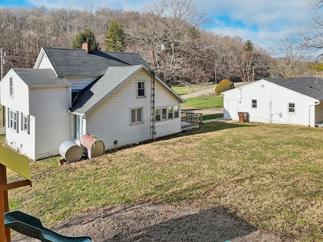 view of side of home with a lawn and a deck