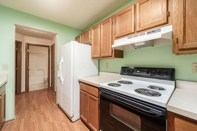 kitchen featuring light hardwood / wood-style floors and white appliances