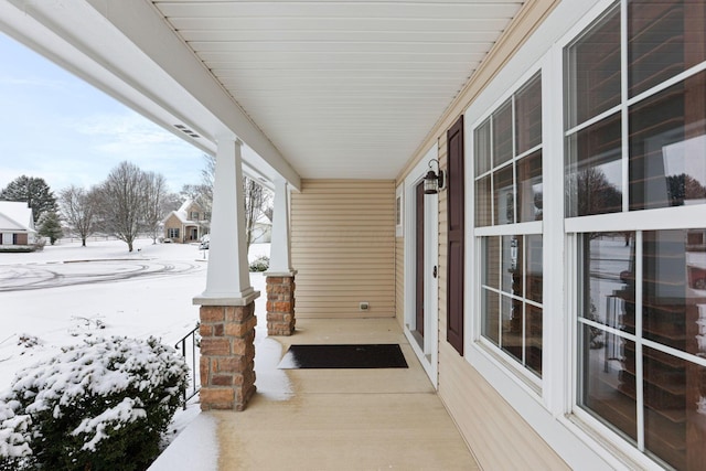 snow covered patio with covered porch