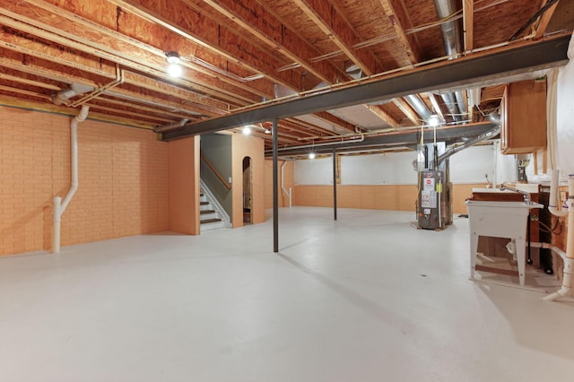 basement with brick wall and water heater