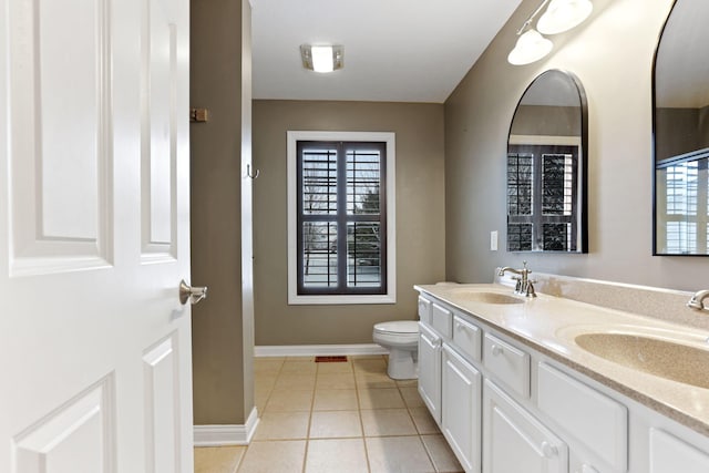 bathroom featuring tile patterned flooring, vanity, and toilet