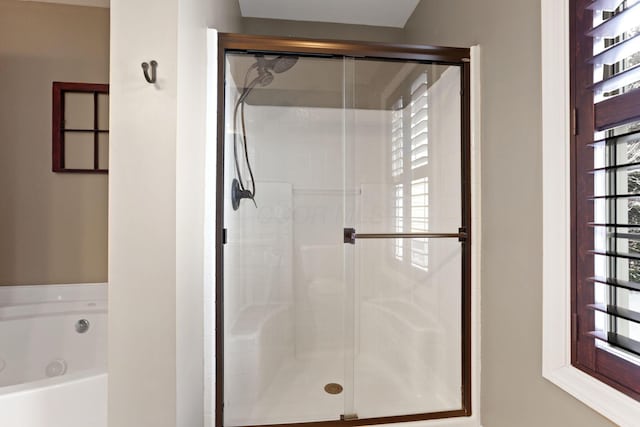 bathroom featuring shower with separate bathtub