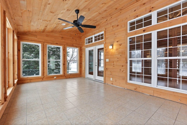 unfurnished sunroom featuring plenty of natural light, ceiling fan, lofted ceiling, and wood ceiling